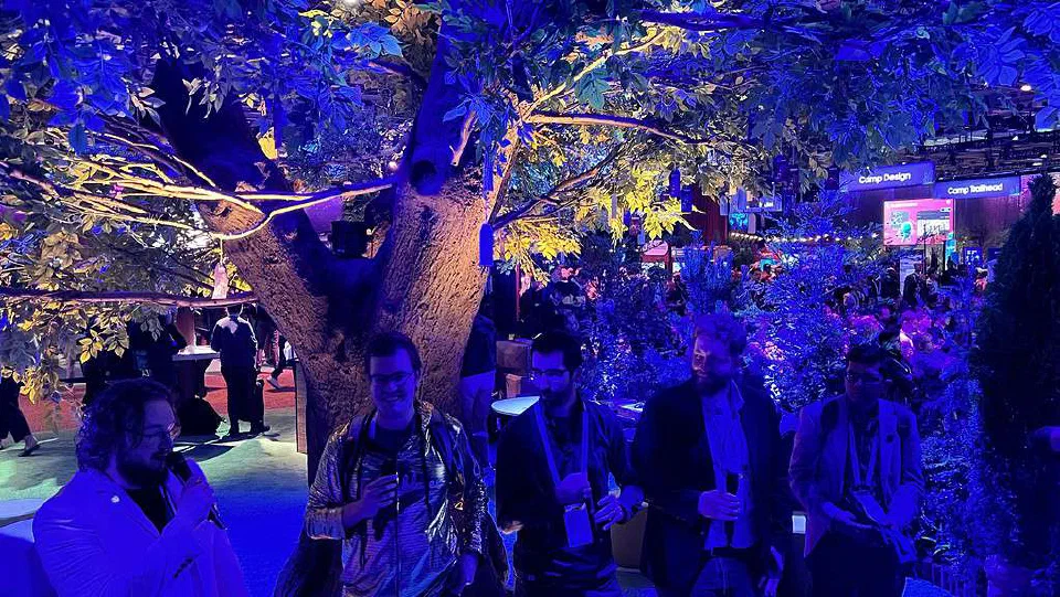 The Unofficial SFCC slack admins below a tree at Dreamforce in dim blue lighting.
